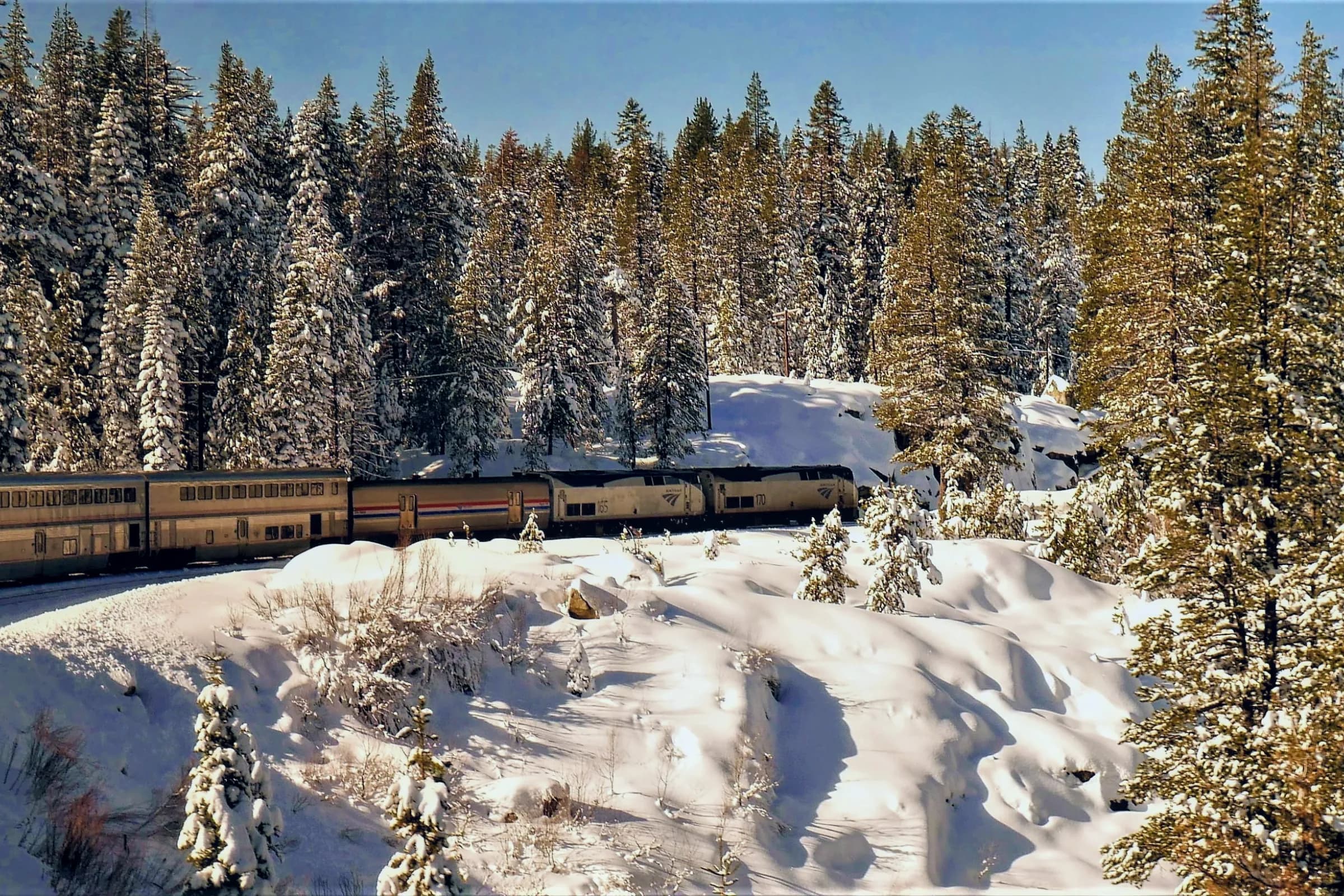 Amtrak train travelling through the Sierra Nevada Mountains during winter