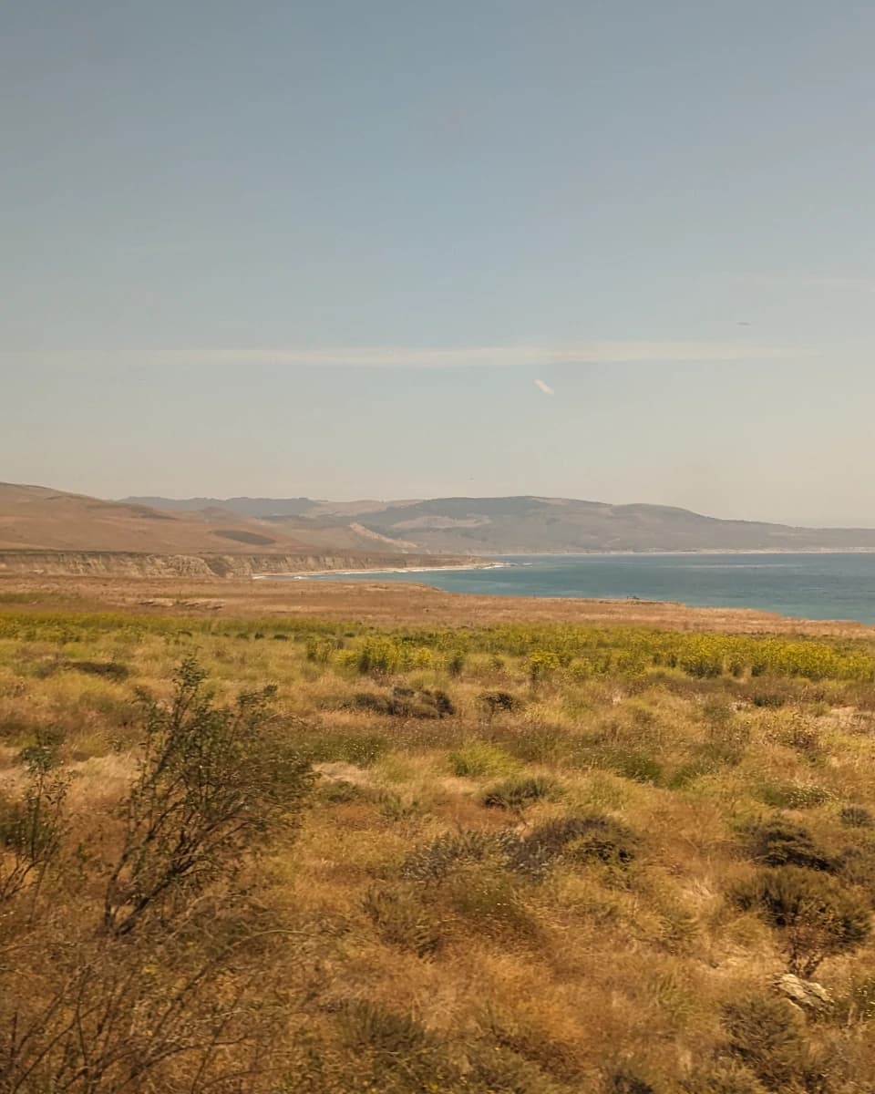 Grassland and the Pacific Coast as seen from Coast Starlight between Los Angeles and San Francisco
